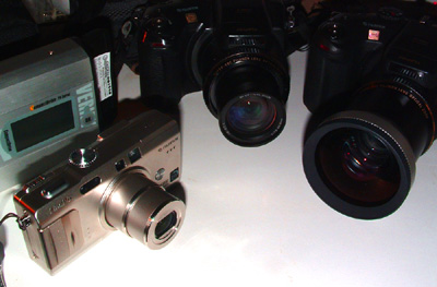 Her er 3 digitale kameraer: I Fuji F810 som Peter  Møllmann har købt, samt mine 2 Fuji S7000, den ene er der monteret en vidvinkelforsats, samt en rejsehardisk med 40 GB hukommelse. Det skulle være nok til en sommerfugletur i 4 uger i januar, syd for ækvator i Sydamerika. d. 4 december 2004. Fotograf: Lars Andersen